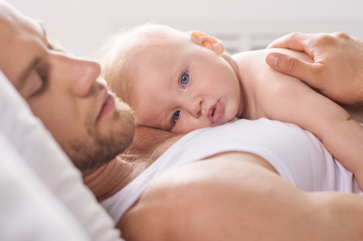 sleeping-dad-with-baby-on-him